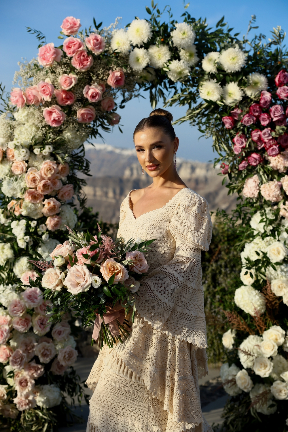 darya osho in atelier zolotas wedding dress in front of flower arch by bloom de fleur